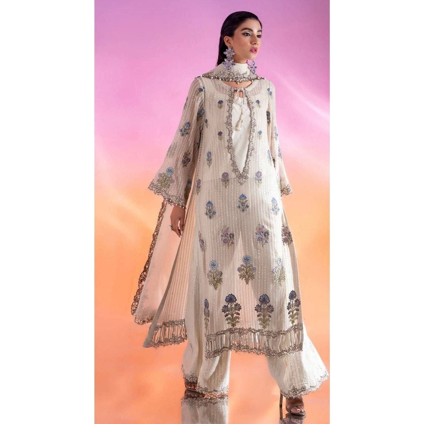 Luxury Embroidered Chiffon Suit – Features an embroidered chiffon shirt with adda and patch work, raw silk blouse and trousers, and an organza dupatta with lace detailing.