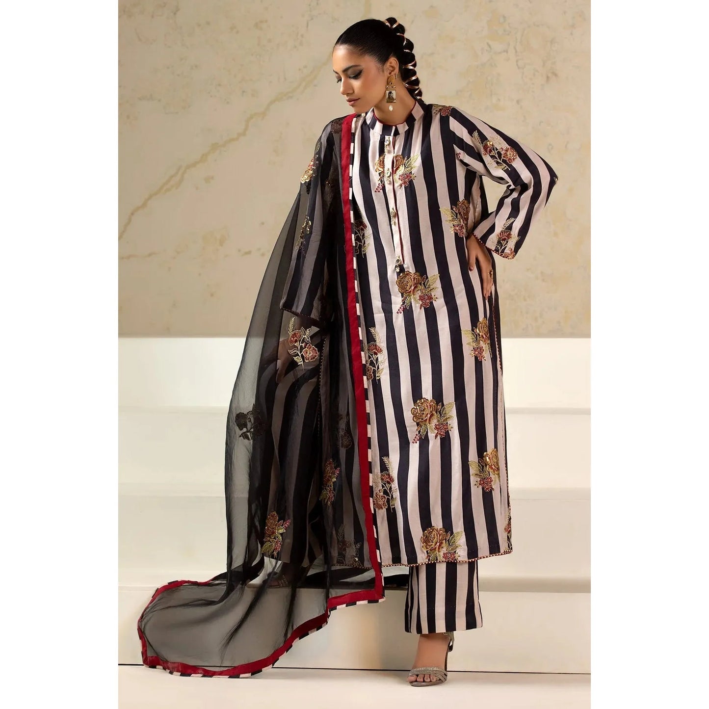Luxury Raw Silk Printed Suit – Embroidered front and sleeves, organza dupatta with motifs, and stitched raw silk trouser for an elegant look.