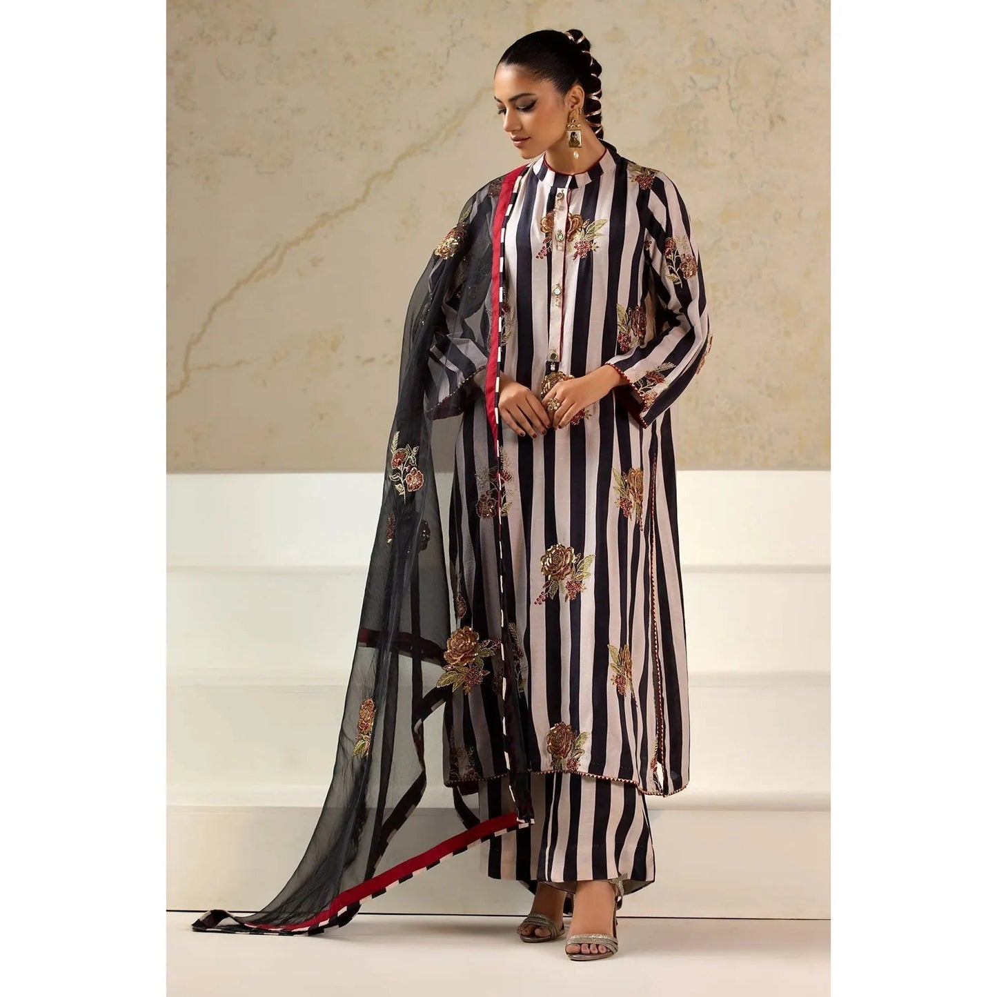 Luxury Raw Silk Printed Suit – Embroidered front and sleeves, organza dupatta with motifs, and stitched raw silk trouser for an elegant look.