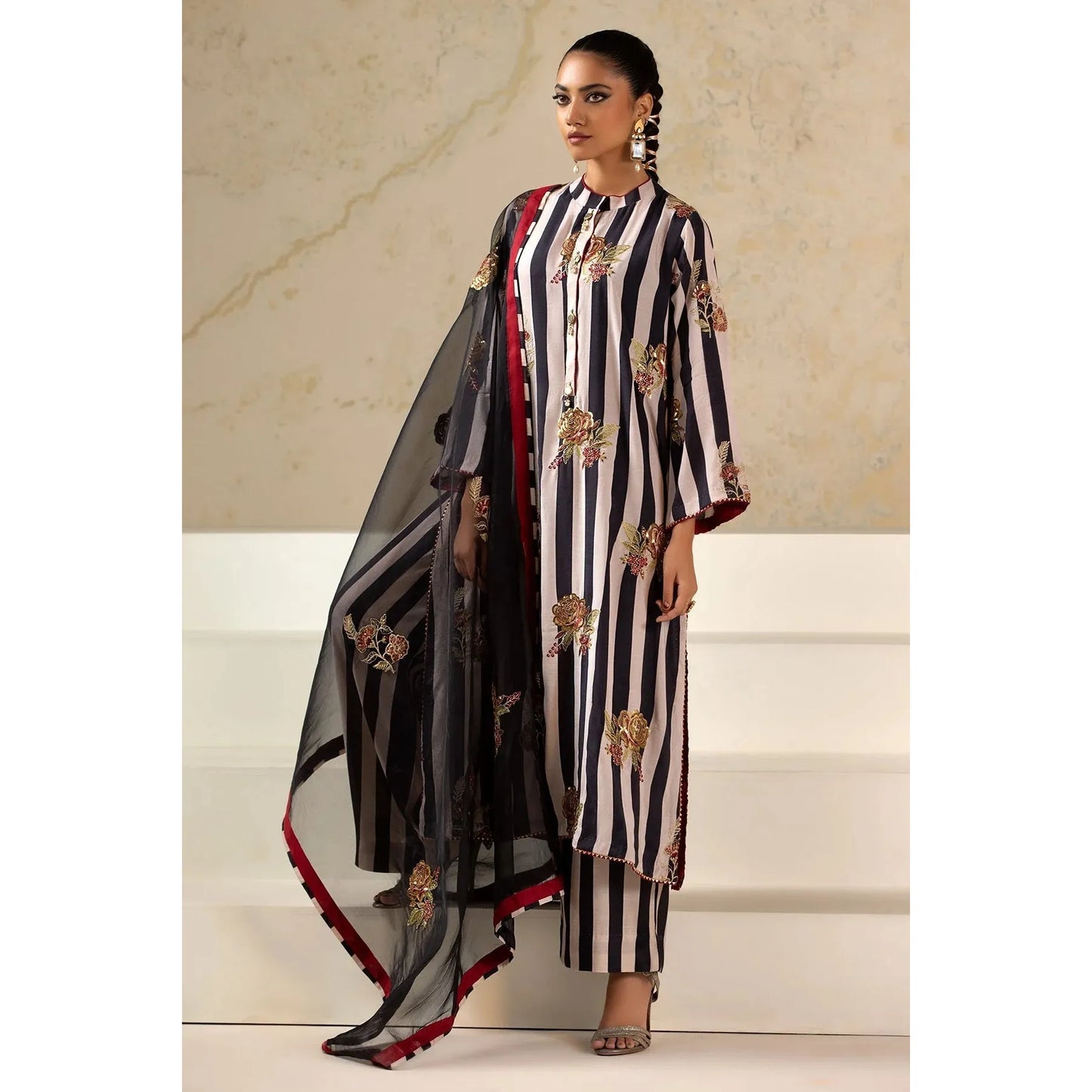 Luxury Raw Silk Printed Suit – Embroidered front and sleeves, organza dupatta with motifs, and stitched raw silk trouser for an elegant look.