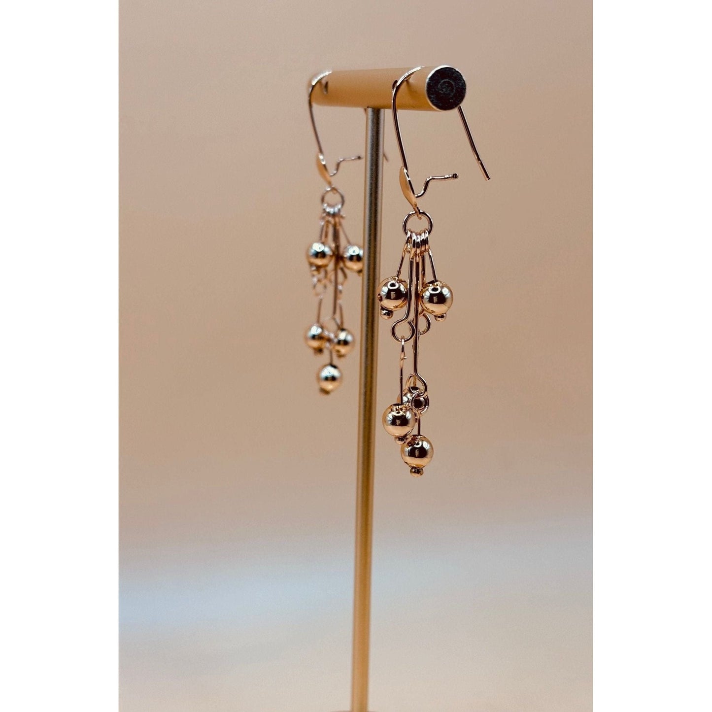 These golden dangling earrings are made with the best quality 1-carat gold plated, ensuring both beauty and durability.