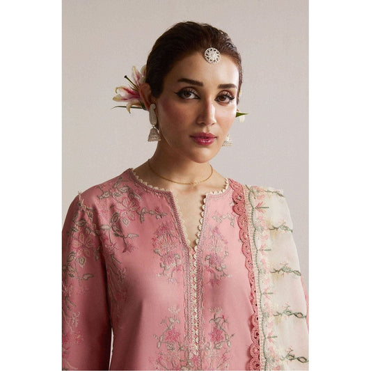 Cool soft pink ensemble with cross-stitch embroidery on premium lawn fabric, featuring alluring floral motifs in ivory, pink, and green hues. Paired with a contrast-colored chiffon embroidered dupatta and printed cotton trouser, this modern yet traditional outfit exudes timeless elegance. Perfect for festive occasions, this luxurious Pakistani clothing offers intricate craftsmanship and ethereal beauty.