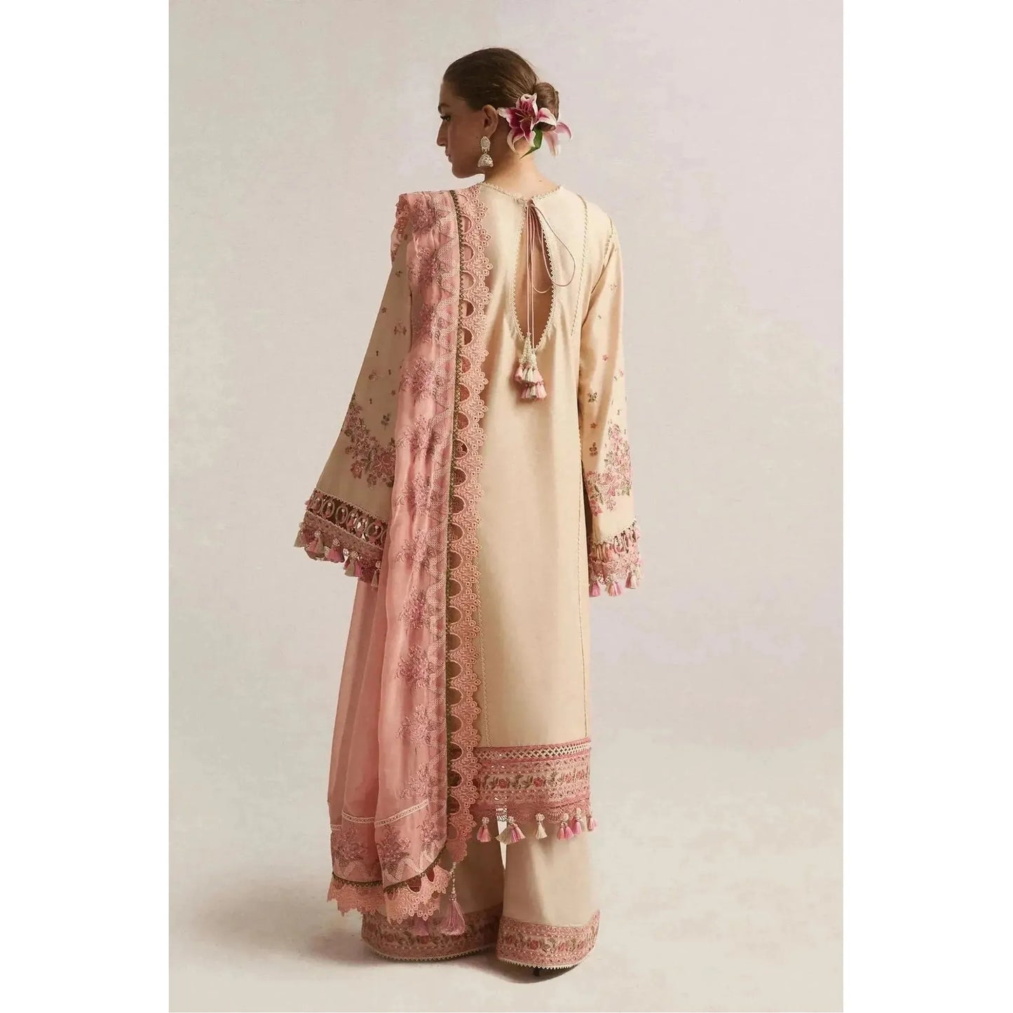 Hussain Rehar minimalistic lawn shirt with intricate embroidery on the front and sleeves, paired with a contrast embroidered chiffon dupatta. Complete with same dyed cotton trousers featuring an embroidered border, this elegant summer ensemble combines simplicity and sophistication. Ideal for casual and semi-formal occasions, this luxury Pakistani clothing design offers timeless style and comfort for warm weather