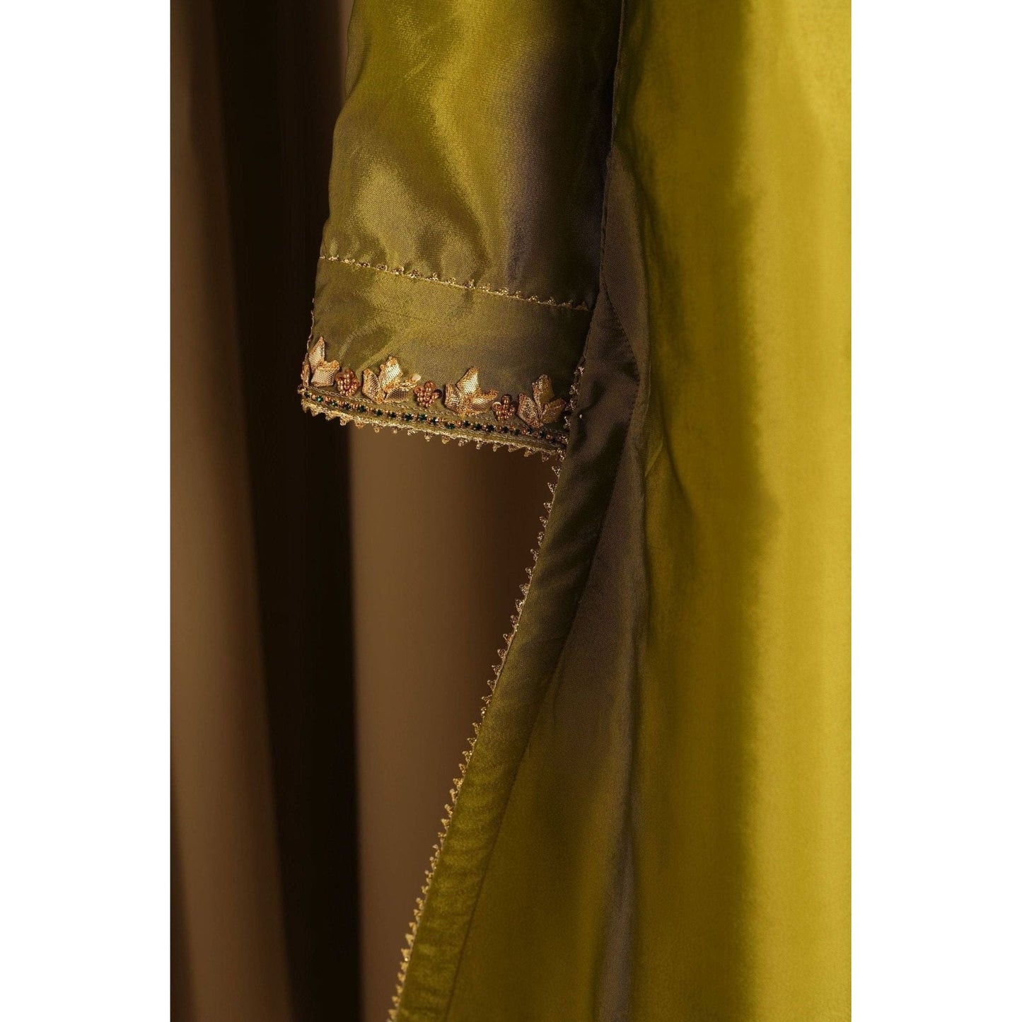 close up of Mehndi-colored silk hand-embroidered gota gharara suit with crystal work.