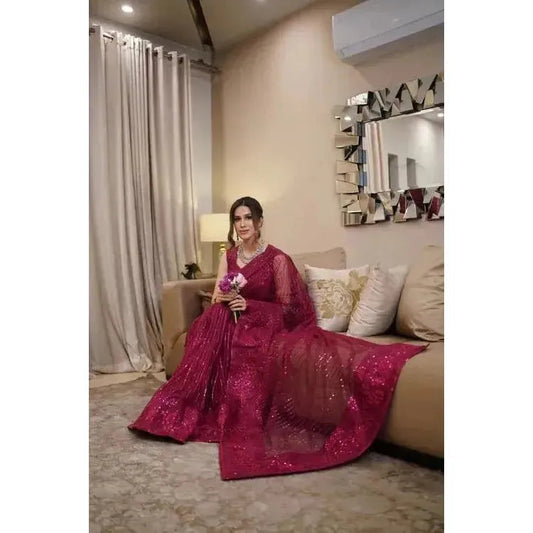 Stitched Sari comes with attached sleeves embroidered with sequince work in the majenta color. Made in Pakistan, it’s available for purchase at najmaDesigns and co.