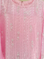 Close-up of a pink fabric with silver floral embroidery