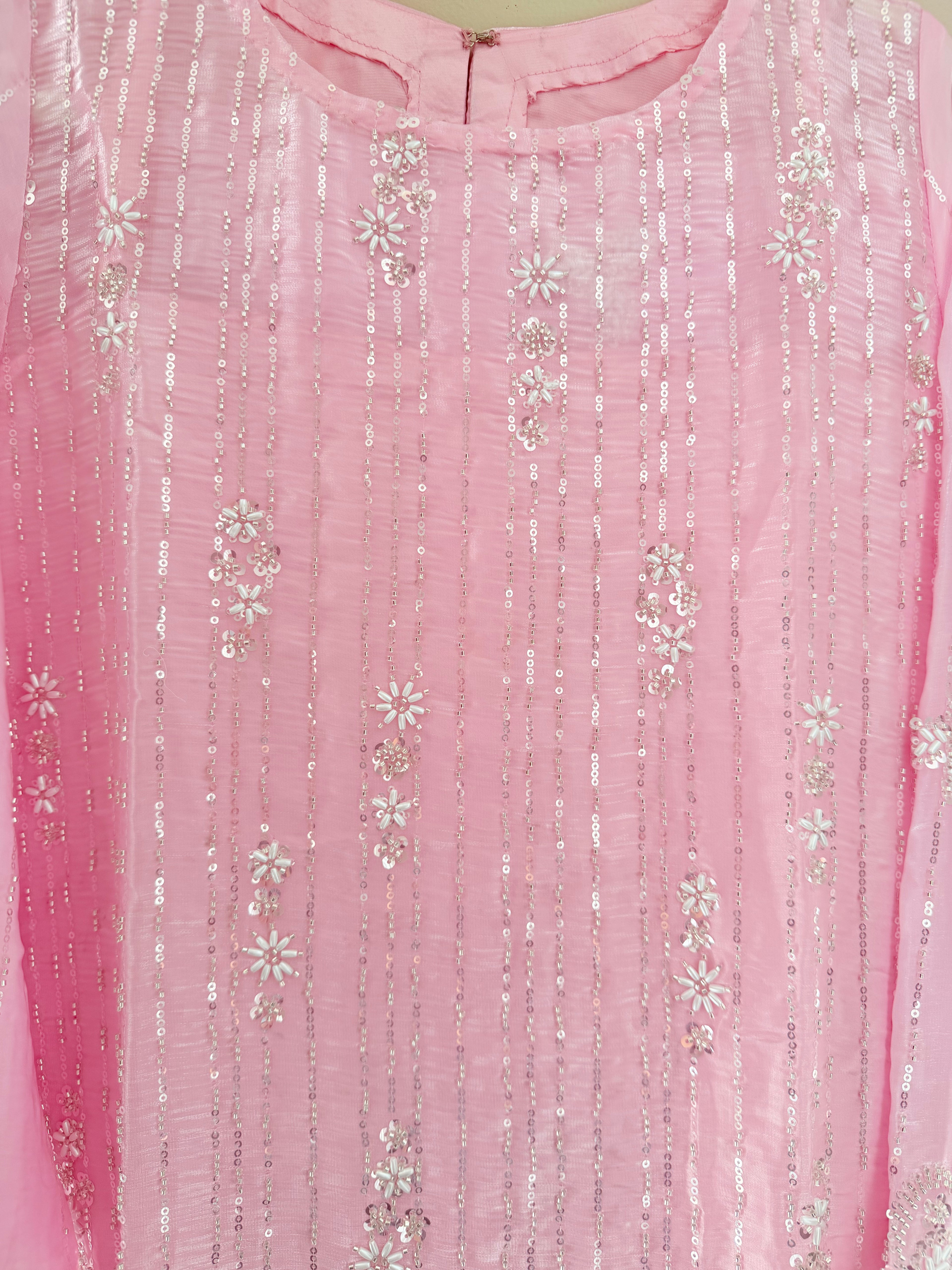 Close-up of a pink fabric with silver floral embroidery