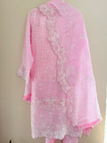Pink embroidered fabric on a beige background