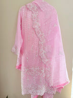 Pink embroidered fabric on a beige background