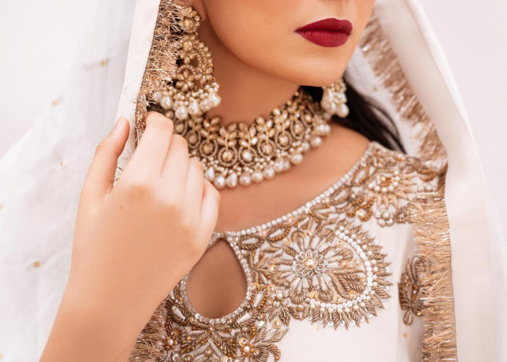 • Clothing: Embroidered/Printed suit for women - Made of best quality fabric - lawn or linen or chiffon - pure silk - Available at Najma Designs & Co. • Jewelry: Gold - plated stud earrings for