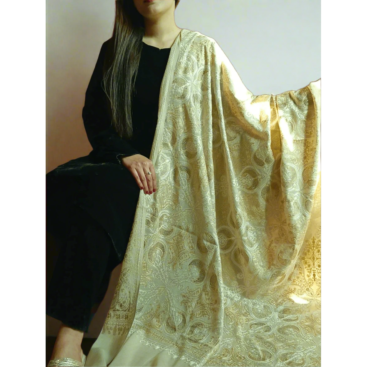 A beige shawl intricately embroidered with Kashmiri designs and studded with crystals is available for purchase. Crafted in Pakistan, this exquisite piece is offered by Najmadesigns and Co. in the United States and Canada. 