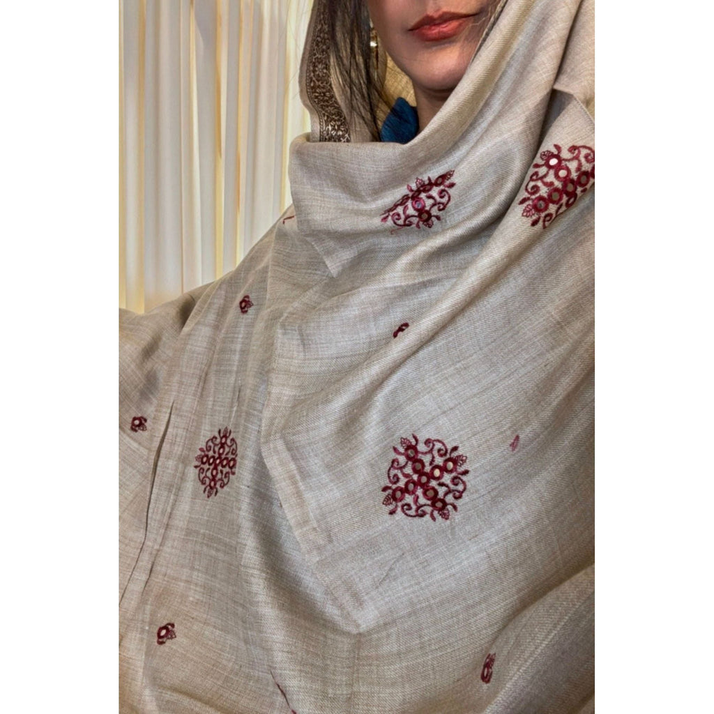 A beautiful light gray brown shawl with maroon embroidery. It is lightweight and suitable for both casual and formal wear. The brand name is Stylo Pk. It is available for purchase in the United States at Najmadesighns and Co.