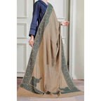 on a model Brown Winter Shawl with Sea Green, Traditional Embroidery Shawl
This camel brown shawl features exquisite sea green embroidery, creating a visually stunning piece. The shawl is available for purchase at Najmadesighns and Co., a reputable online retailer based in the United States.