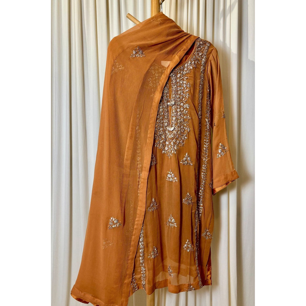 A chiffon fabric burnt orange  outfit with hand embroidery. by Najmadesigns and co. gotta work 