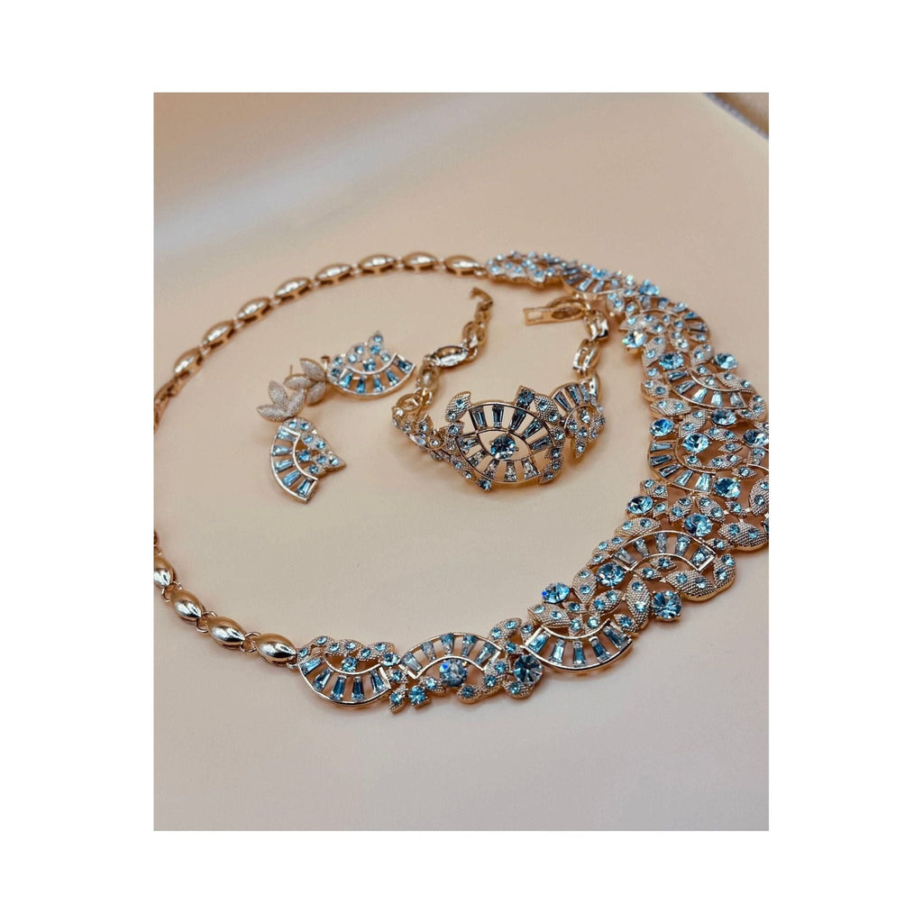 One karat gold plated. This stunning crystal bridal set includes a beautiful bracelet and a stunning, eye-catching necklace. 