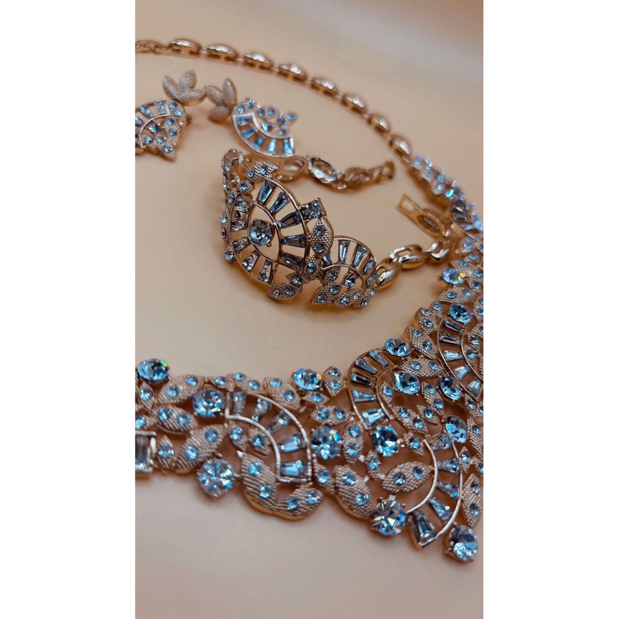 One karat gold plated. This stunning crystal bridal set includes a beautiful bracelet and a stunning, eye-catching necklace. 