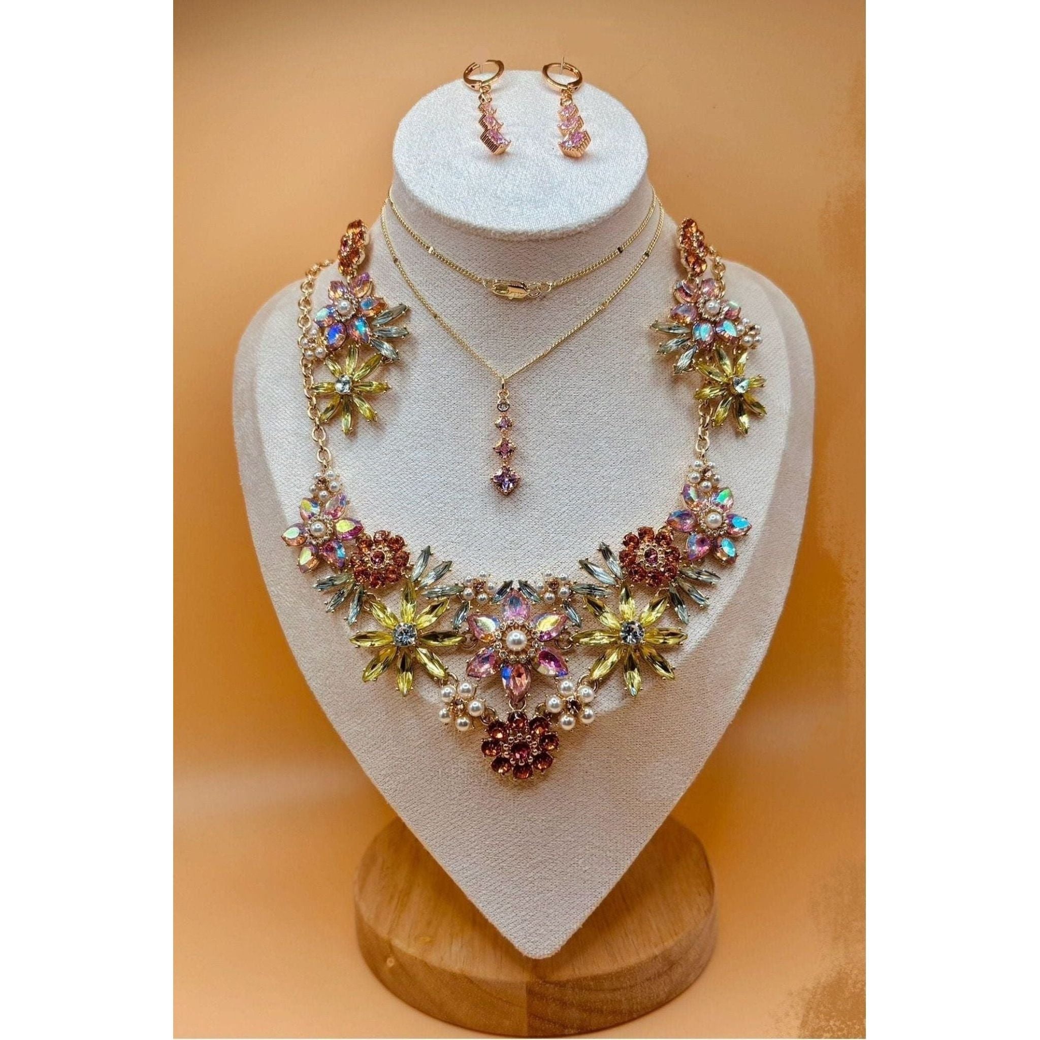 The Crystal Flower Jewel Set boasts an exquisite collection of multi-colored flowers, exuding elegance and sophistication in any ensemble. This exquisite jewelry set is available for purchase in Pakistan and Canada through Najmadesigns and Co. 