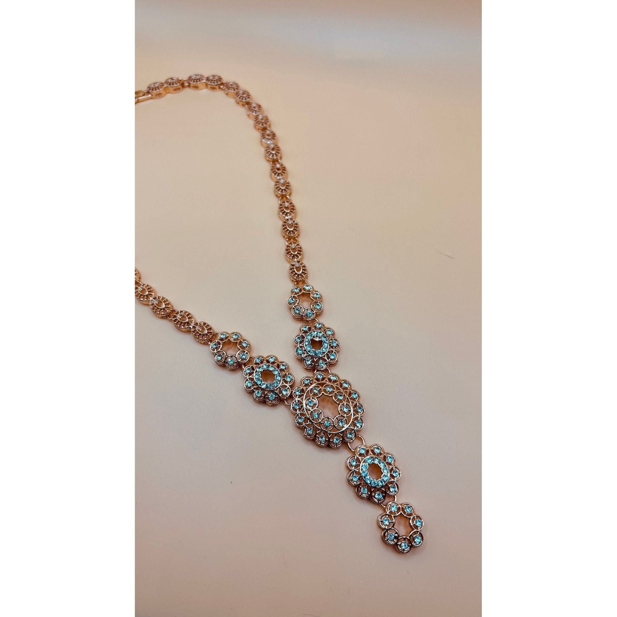 This refined jewelry set boasts a stunning bracelet, a dazzling ring, a graceful necklace, and exquisite earrings.