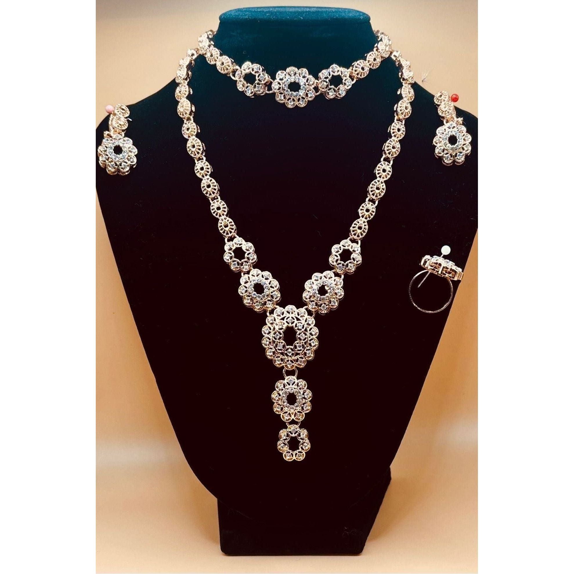 This refined jewelry set boasts a stunning bracelet, a dazzling ring, a graceful necklace, and exquisite earrings.