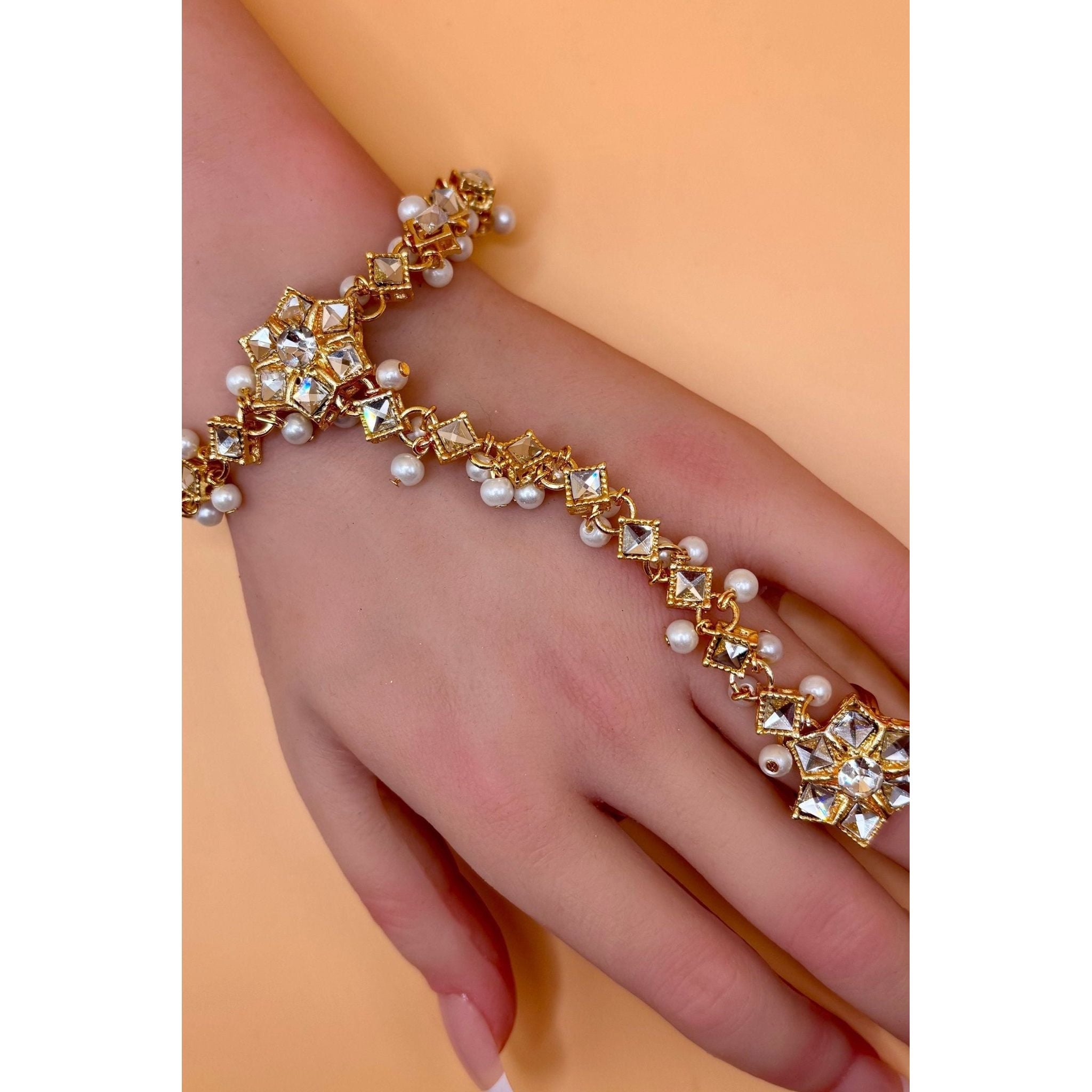 Crafted from top-quality materials, this hand bracelet with ring is an elegant and high-quality accessory. Perfect for adding a touch of sophistication to any outfit, this bracelet is sure to catch the eye with its flawless design and excellent craftsmanship. Elevate your style with this must-have piece.&nbsp;