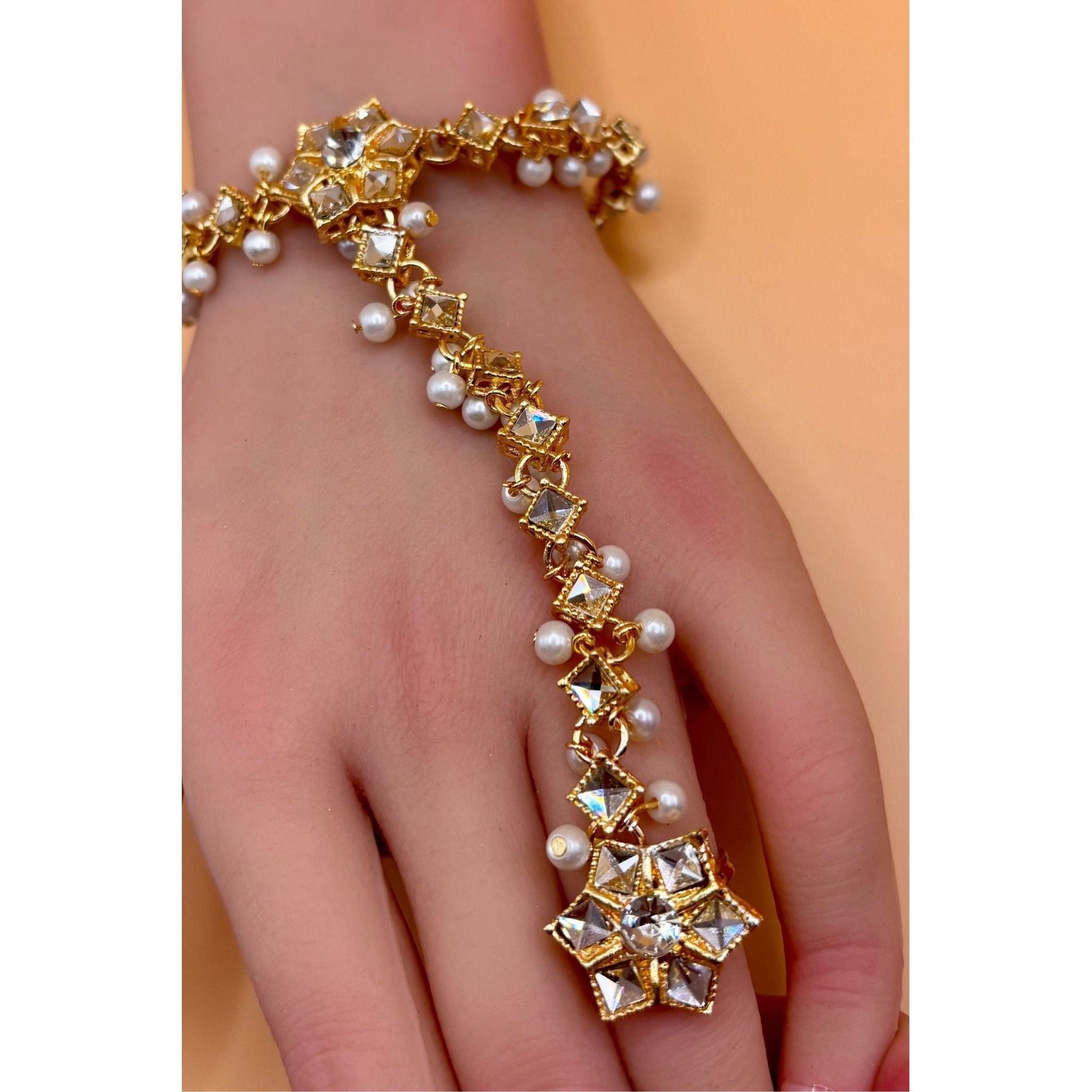 Crafted from top-quality materials, this hand bracelet with ring is an elegant and high-quality accessory. Perfect for adding a touch of sophistication to any outfit, this bracelet is sure to catch the eye with its flawless design and excellent craftsmanship. Elevate your style with this must-have piece.&nbsp;