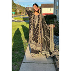 A stunning black suit adorned with beige and gold embroidery, complemented by a dupatta and plazzu pants also embroidered with intricate designs.