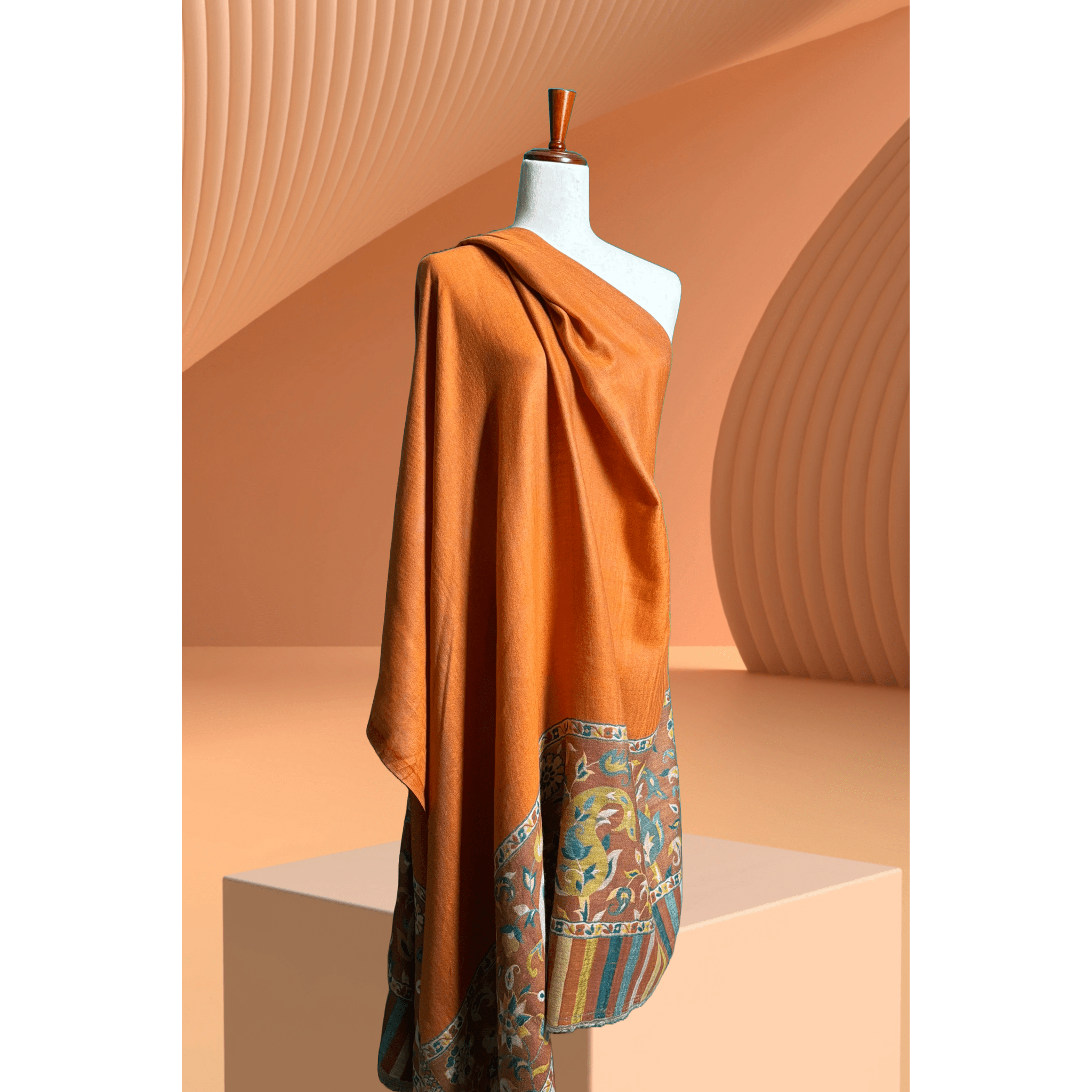 A lightweight, exquisite Shawl woven from Kani yarn in burnt orange hues. The Shawl features a pure silk Pashmina base and a delicate grey border. 