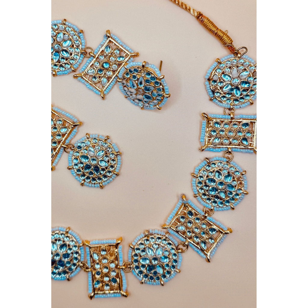 This antique jewelry piece includes earrings and a necklace. 
