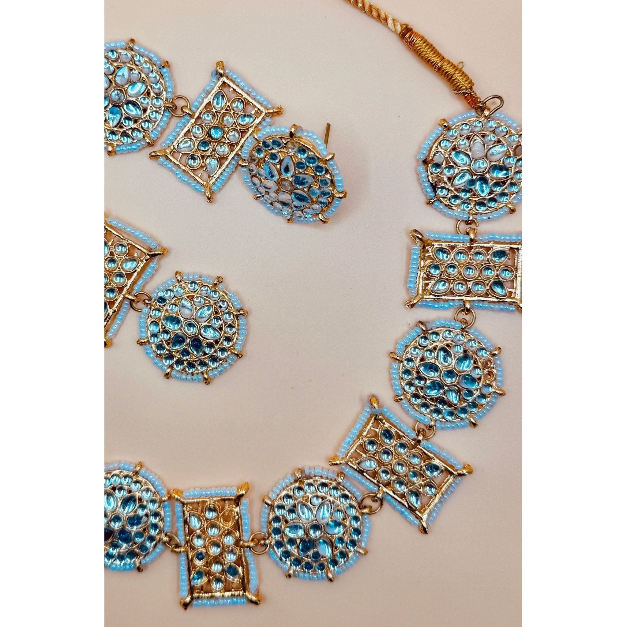 This antique jewelry piece includes earrings and a necklace. 