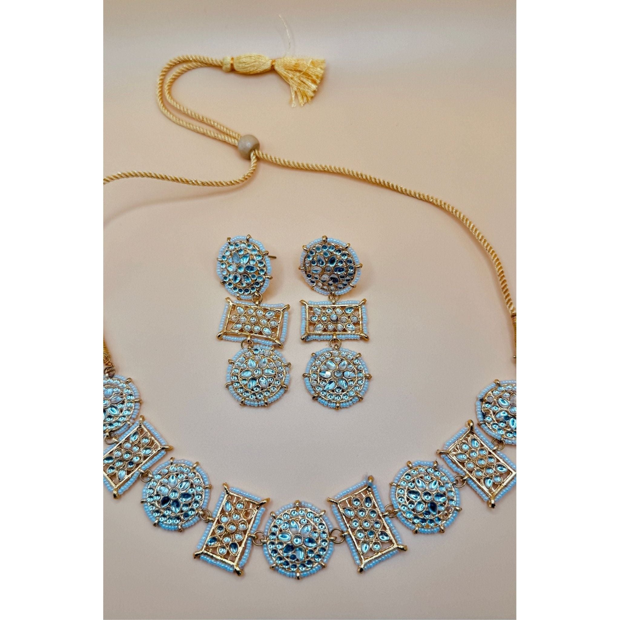 This antique jewelry piece includes earrings and a necklace. 