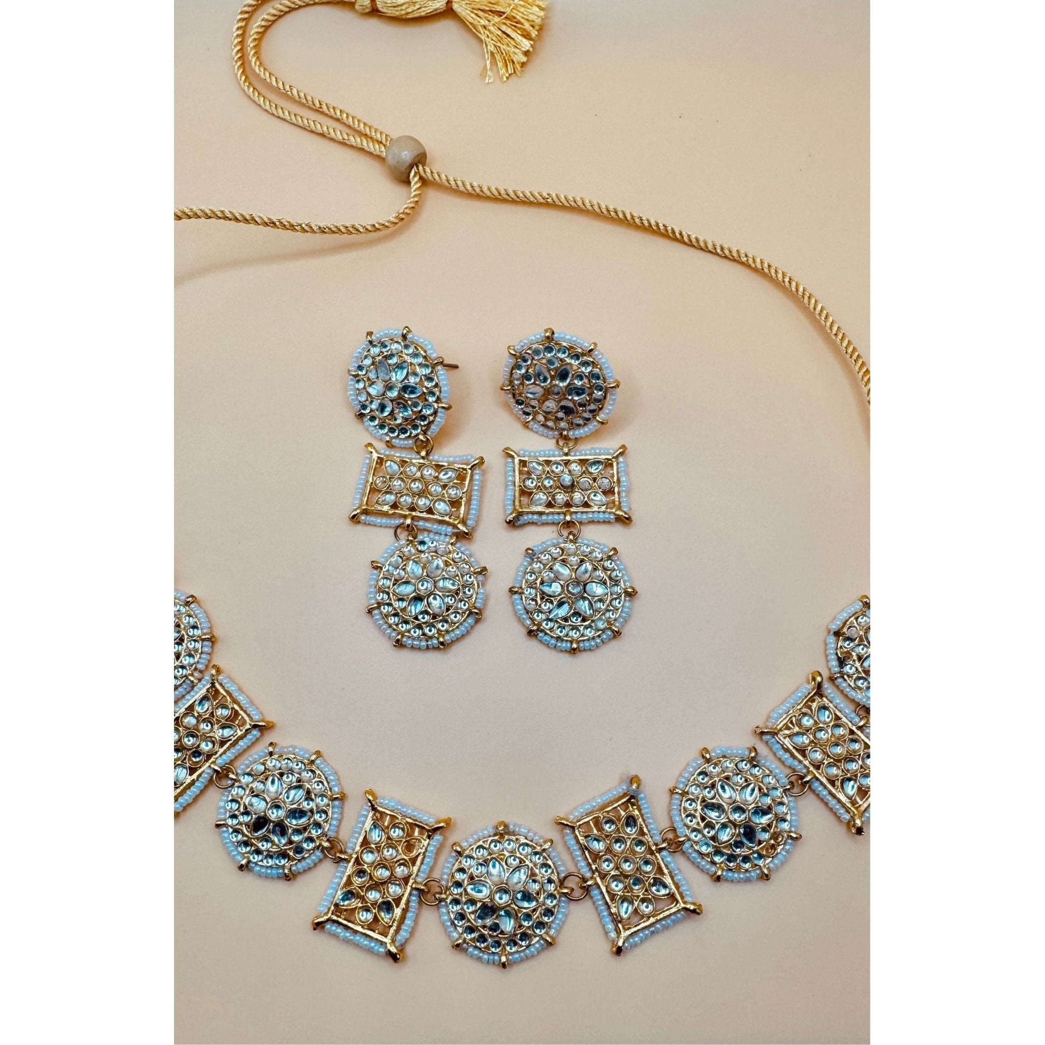 This antique jewelry piece includes earrings and a necklace. 