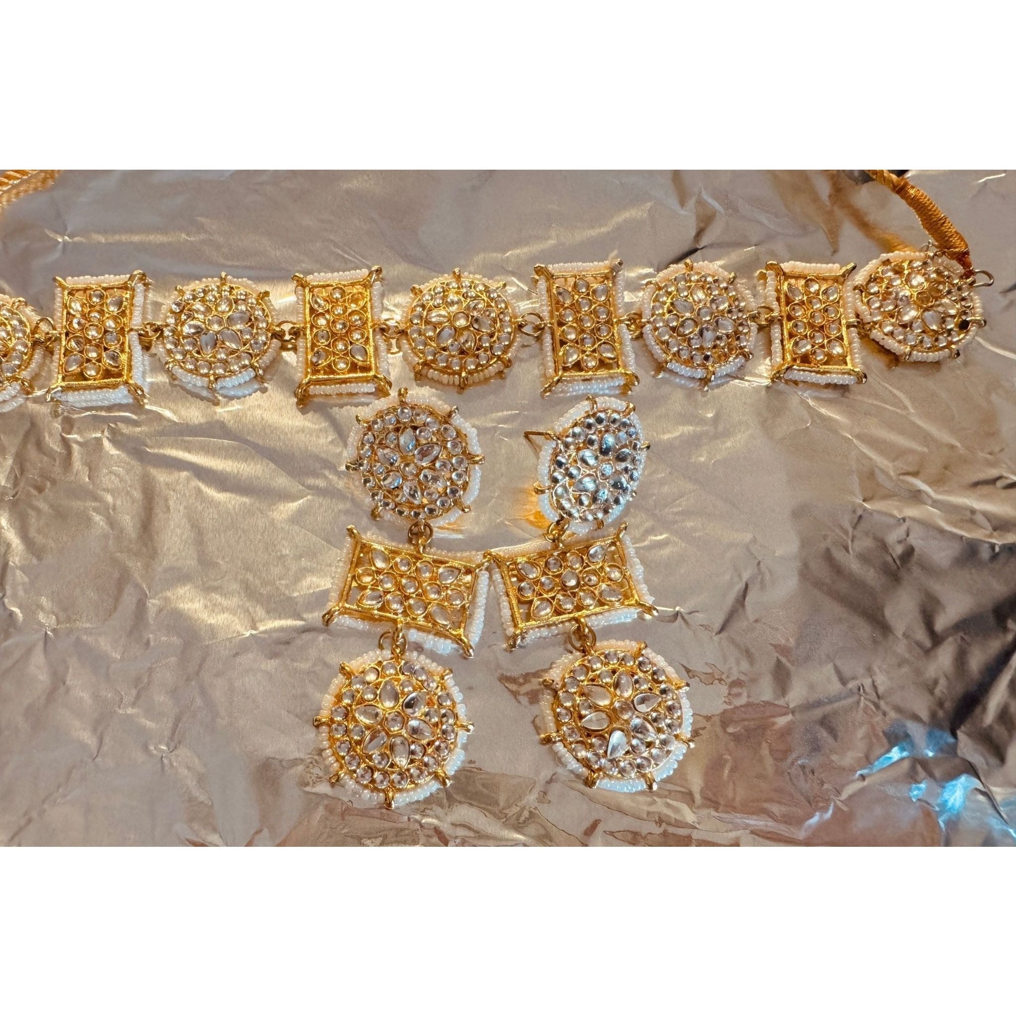 This antique jewelry piece includes earrings and a necklace. 