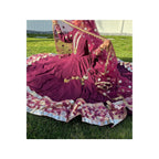	The dress boasts a Peshwas-style design, adorned with 10 yards of vibrant flair, meticulously stitched in 32 kaliyahs or panels. It features three layers, with a crinoline slip attached, and a mulberry-colored Banarasi border. The designer behind this exquisite creation is Naijamadesigns and Co.
