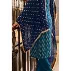 closeup of kameez, and dupatta set adorned with tilla lace, complemented by an outfit color palette of blue and sea green, is fully embroidered. 