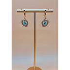 These Ocean Heart Earrings feature a beautiful rhinestone heart shape design, adorned with sparkling crystals. Made with high-quality materials and finished with a 1 carat gold plating, these elegant earrings are sure to elevate any outfit. Dangle them for a touch of sophistication and style.