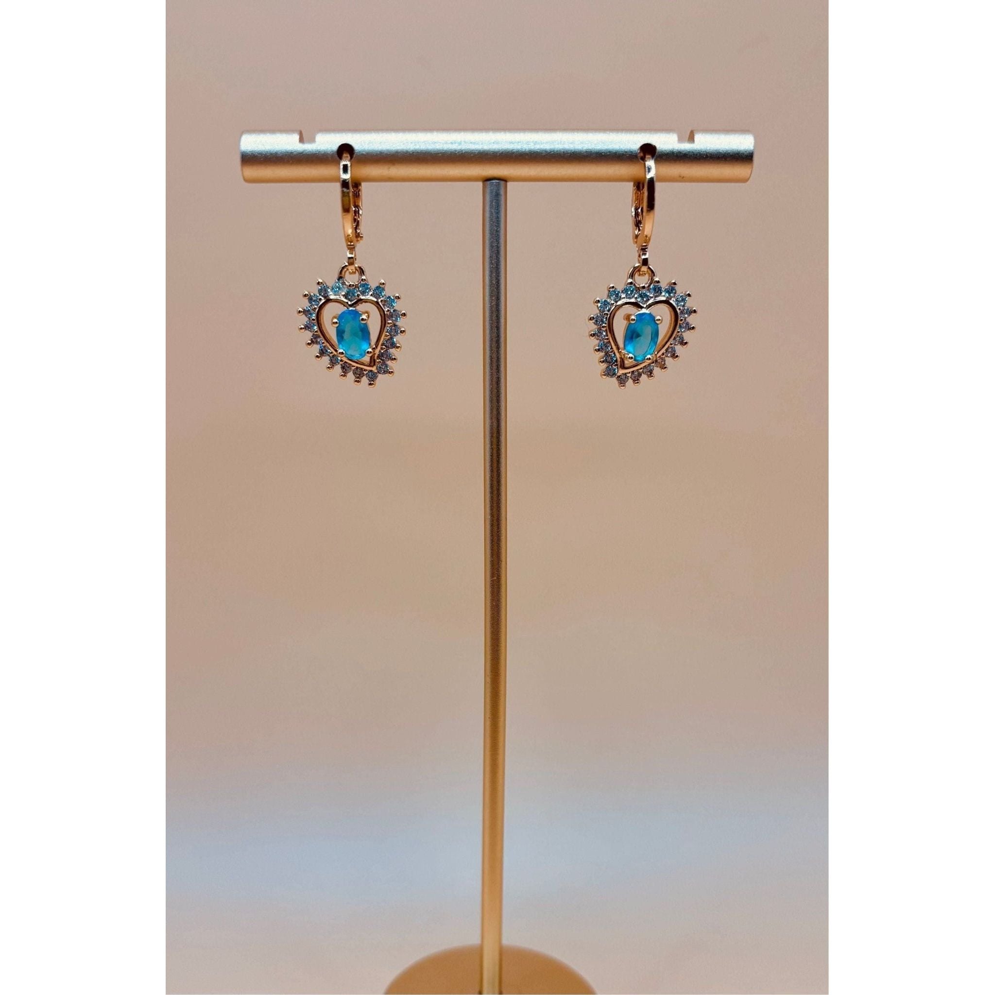 These Ocean Heart Earrings feature a beautiful rhinestone heart shape design, adorned with sparkling crystals. Made with high-quality materials and finished with a 1 carat gold plating, these elegant earrings are sure to elevate any outfit. Dangle them for a touch of sophistication and style.