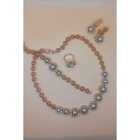 This beautiful pearl set features a one-carat gold setting. It includes an earring bracelet, a ring, and a necklace. 