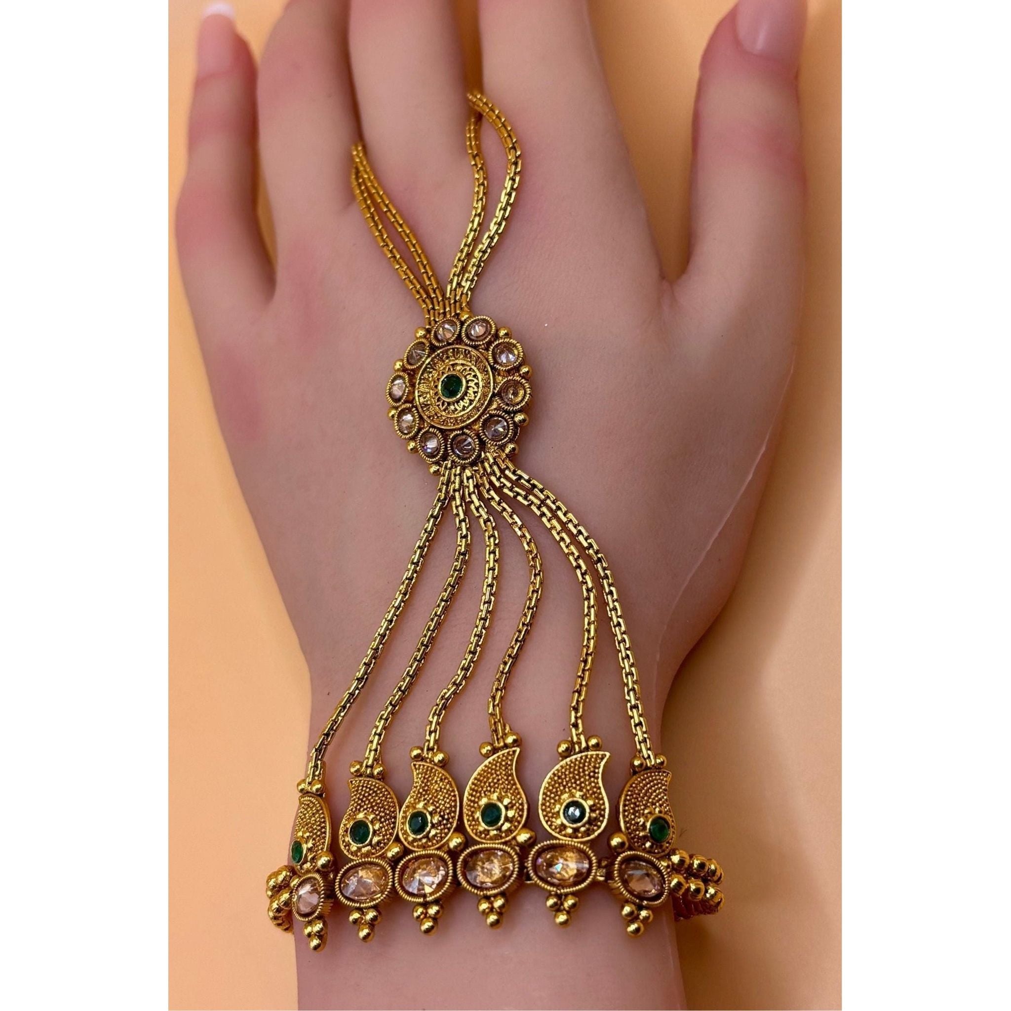 This elegant hand bracelet and ring set is crafted with premium quality brass and features a luxurious gold plating. Its exquisite design and high-quality materials make it a perfect addition to any jewelry collection. Upgrade your style with this premium hand bracelet and ring set today.&nbsp;