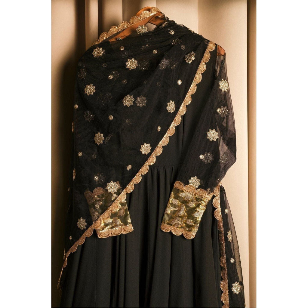 closeup of black pishwash Gown with kalliyan maxi banarasi tissue work on the bottom