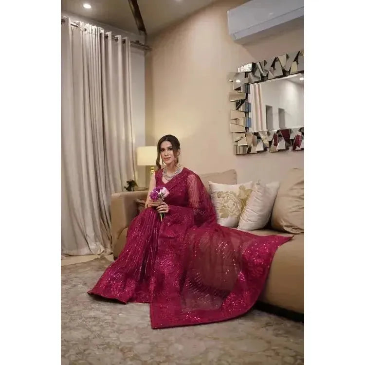 Stitched Sari comes with attached sleeves embroidered with sequince work in the majenta color. Made in Pakistan, it’s available for purchase at najmaDesigns and co.