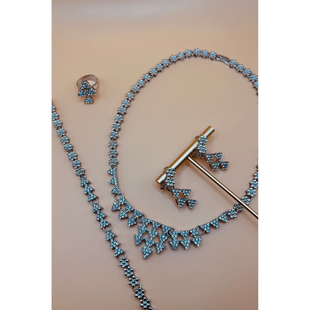 This Silver Crystal Necklace set showcases a beautifully designed triangle silver set, adorned with sparkling crystals. Perfect for formal occasions, this set includes a bracelet, earrings, ring, and necklace, adding an elegant touch to any outfit. Elevate your style with this stunning jewelry set.