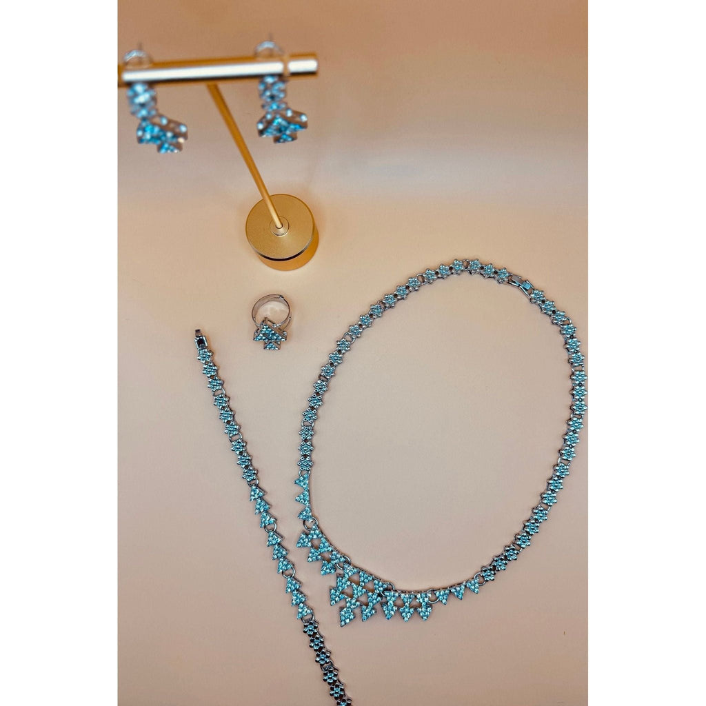 This Silver Crystal Necklace set showcases a beautifully designed triangle silver set, adorned with sparkling crystals. Perfect for formal occasions, this set includes a bracelet, earrings, ring, and necklace, adding an elegant touch to any outfit. Elevate your style with this stunning jewelry set.