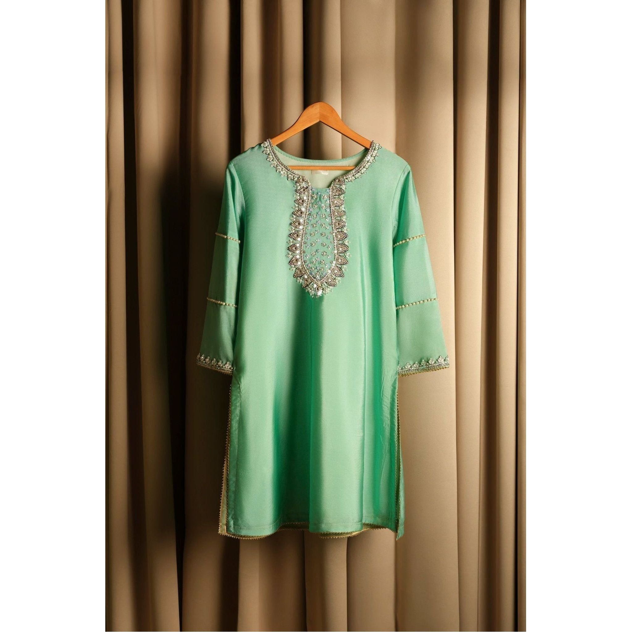 	•	Product Description: Beautiful raw silk sharara suit with silver hand embroidery.
	•	Color: Light pastel green.
