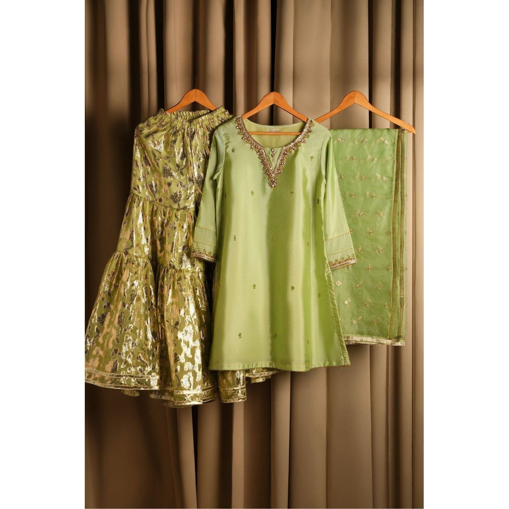 Product Description: Beautiful raw silk Gharara suit with gold hand embroidery with crystals Color: Lime green.